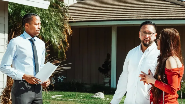 Neighbors and a homeowner talking outside a house about community concerns and relationships